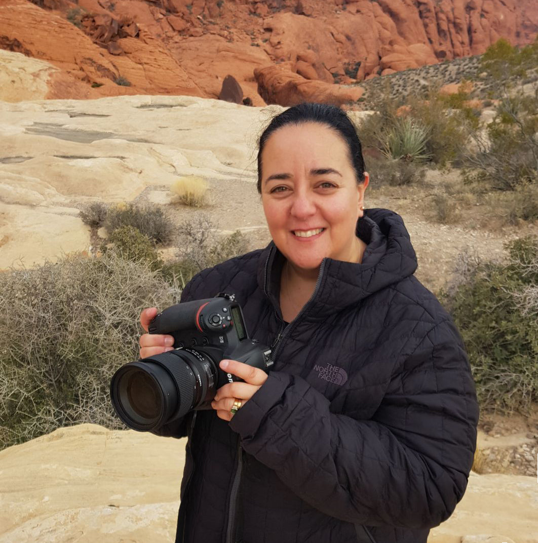 Lisa Saad of Gotham Studios Collective holding a camera in a desert landscape